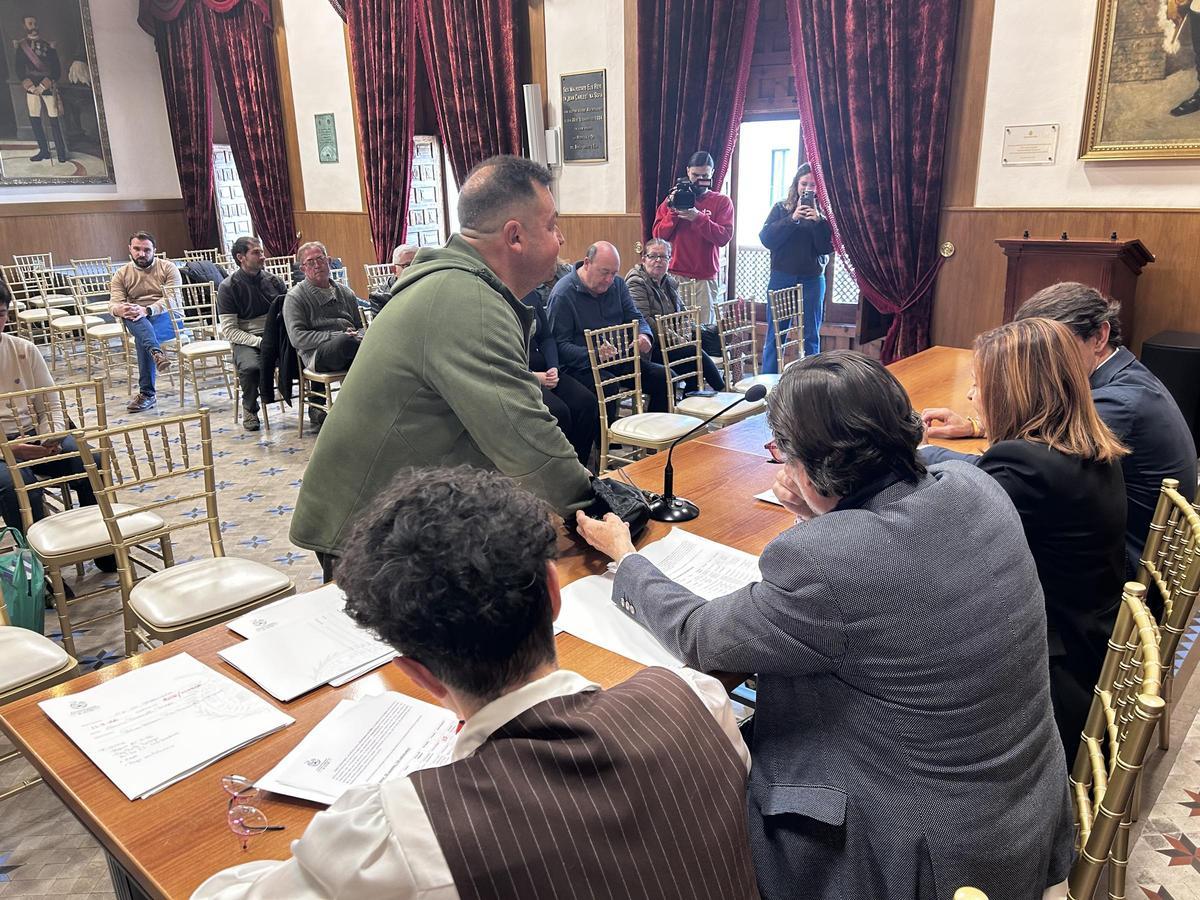 Uno de los vendedores de palma blanca coge su número en el sorteo del Ayuntamiento de Elche