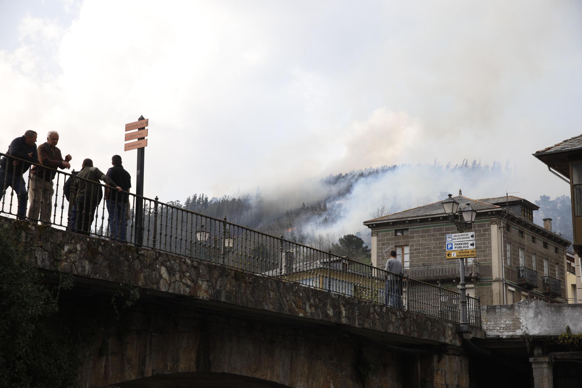 Agricultores ayudando en la extinción de los focos de fuego y enfriando las inmediaciones de la gasolinera de Navelgas