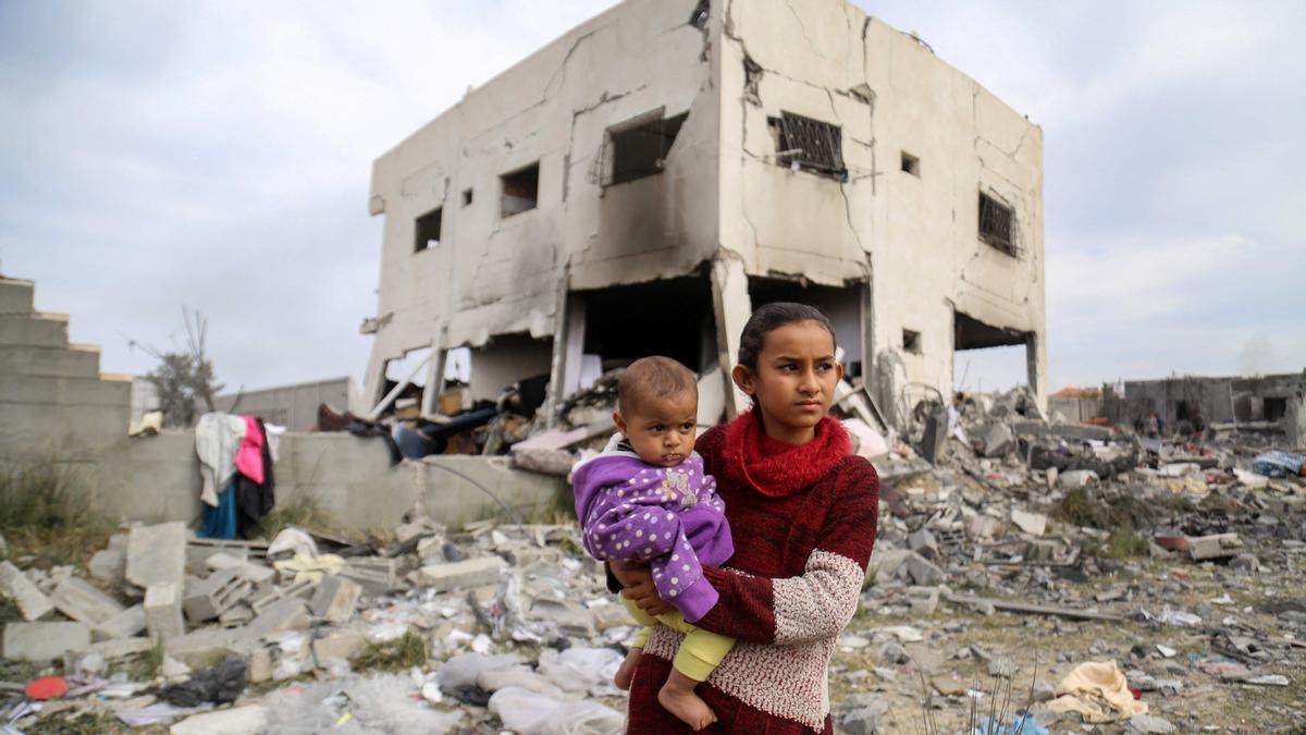 Los palestinos buscan entre los escombros de la casa de la familia Tabatibi, tras el bombardeo israelí nocturno en Gaza / AFP