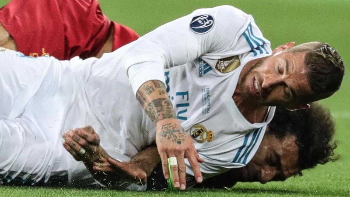 Sergio Ramos cae sobre Salah tras la disputa de un balón y le lesiona.