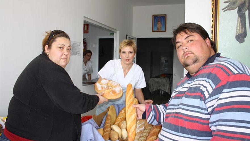 Usuarios del comedor social de Emaús en Antequera, junto a una trabajadora.