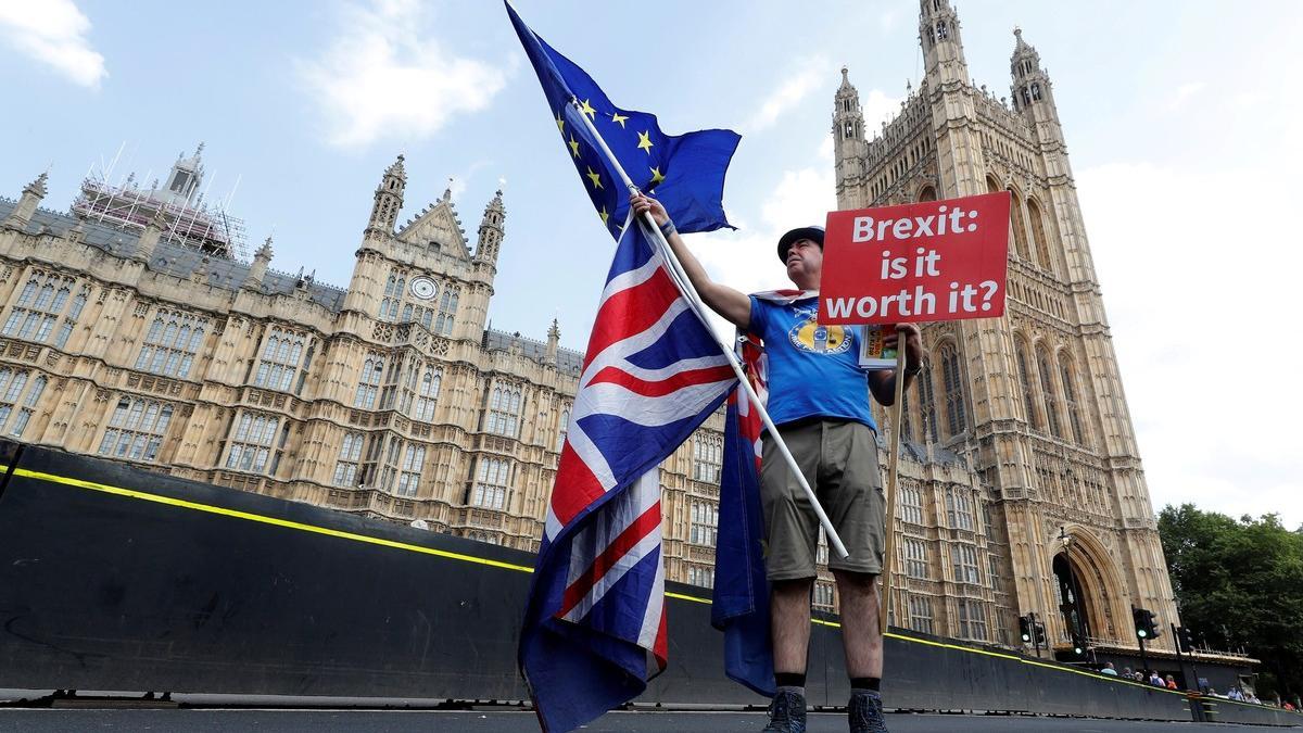 FILE PHOTO: A man holds an anti-Brexit banner on Westminster Bridge in central London