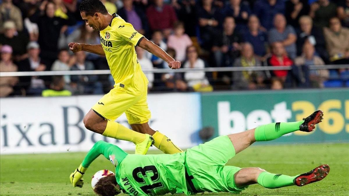 Oblak se estira para evitar el gol de Bacca.