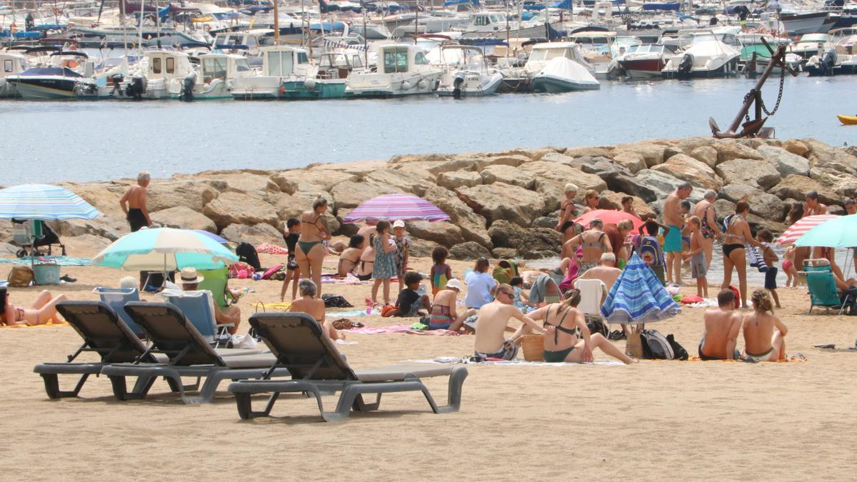 Diverses persones a la platja de Sant Feliu de Guíxol