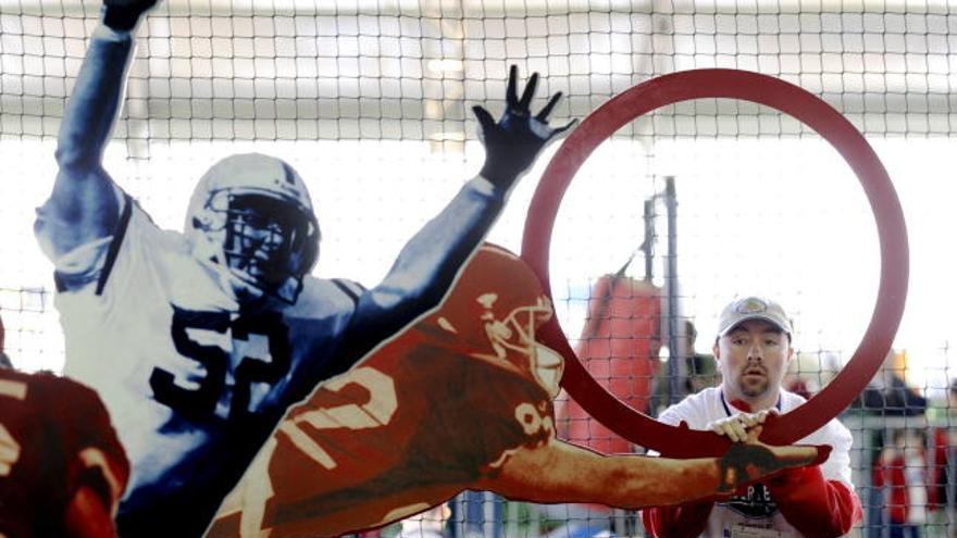 Un hombre posa  junto a una de las atracciones en el Complejo de la Liga Nacional de Fútbol Americano (NFL), afuera del estadio Raymond James de Tampa, Florida (EEUU), donde el próximo domingo 1 de febrero se disputará la 43 edición del Super Bowl de la NFL entre los Cardenales de Arizona y los Acereros de Pittsburgh.