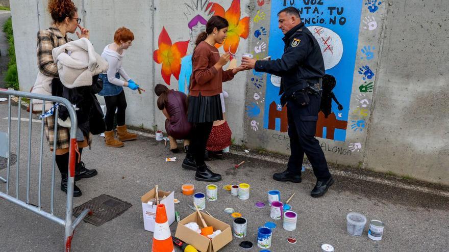 Las estudiantes y un policía, al inicio del trabajo, ayer, en el paseo marítimo. |  Iñaki Abella
