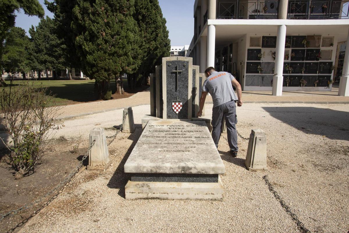 Un operario municipal en el panteón del nazi croata, con el escudo que se tendrá que retirar, en una imagen de archivo.