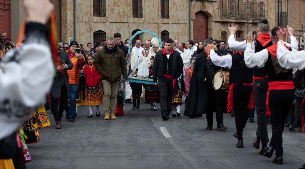 El Niño procesiona por Venialbo, los danzantes bailan frente a él, de espaldas. | A. B.