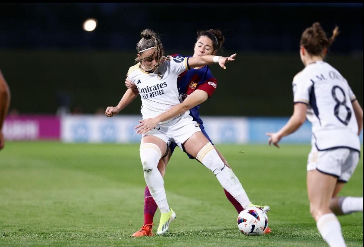 Athenea del Castillo y Marta Torrejón disputan un balón en el último 'clásico'.