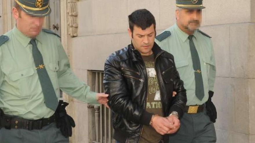 El acusado sale de la Audiencia Provincial esposado y custodiado por la Guardia Civil. / rafa vázquez