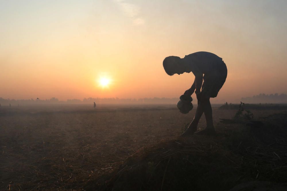 Rohingya refugee boy washes his legs at sunrise ...