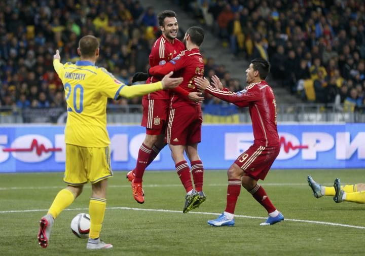 Spain's Gaspar celebrates his goal with team mates Isco and Nolito during their Euro 2016 group C qualifying soccer match against Ukraine at the Olympic stadium in Kiev