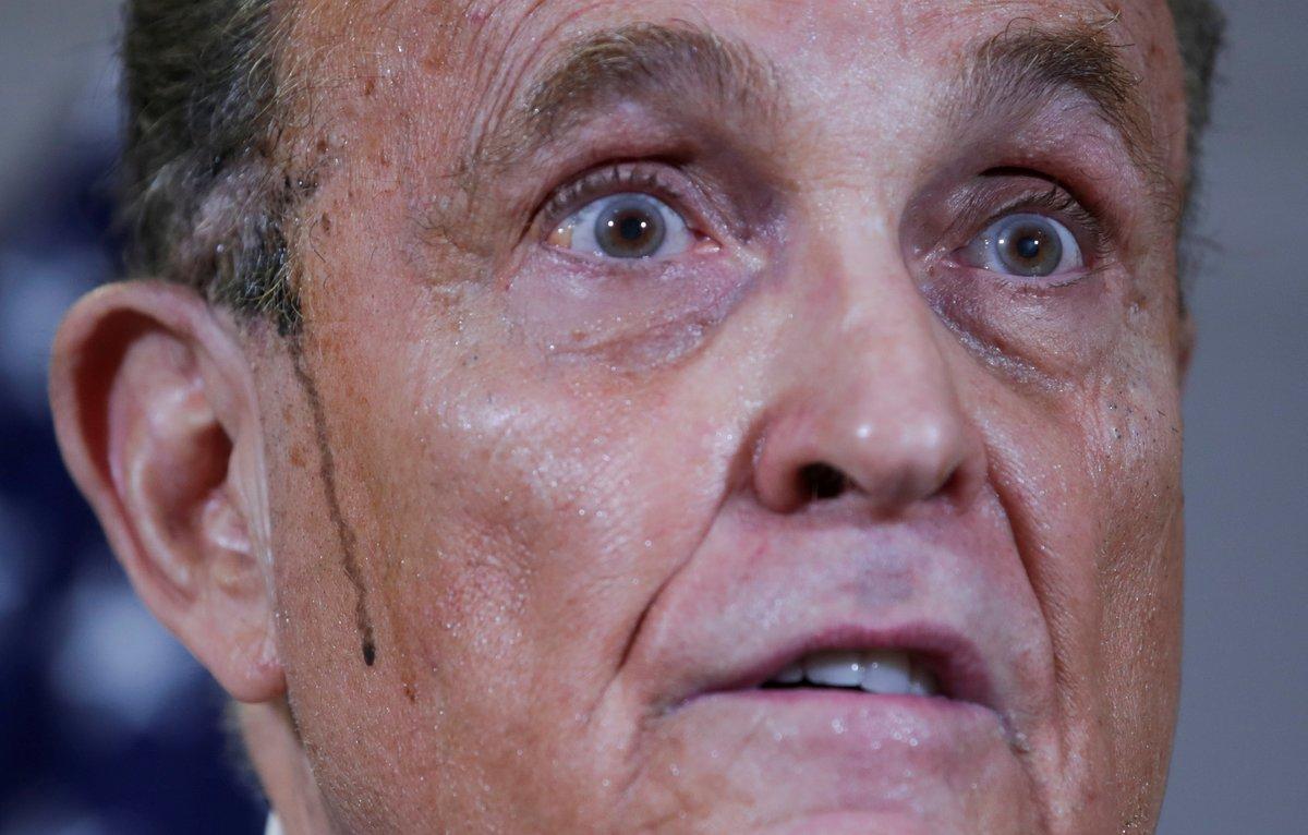 FILE PHOTO: Former New York City Mayor Rudy Giuliani, personal attorney to U.S. President Donald Trump, speaks as sweat runs down his cheek during a news conference about the 2020 U.S. presidential election results held at Republican National Committee headquarters in Washington, U.S., November 19, 2020. REUTERS/Jonathan Ernst/File Photo