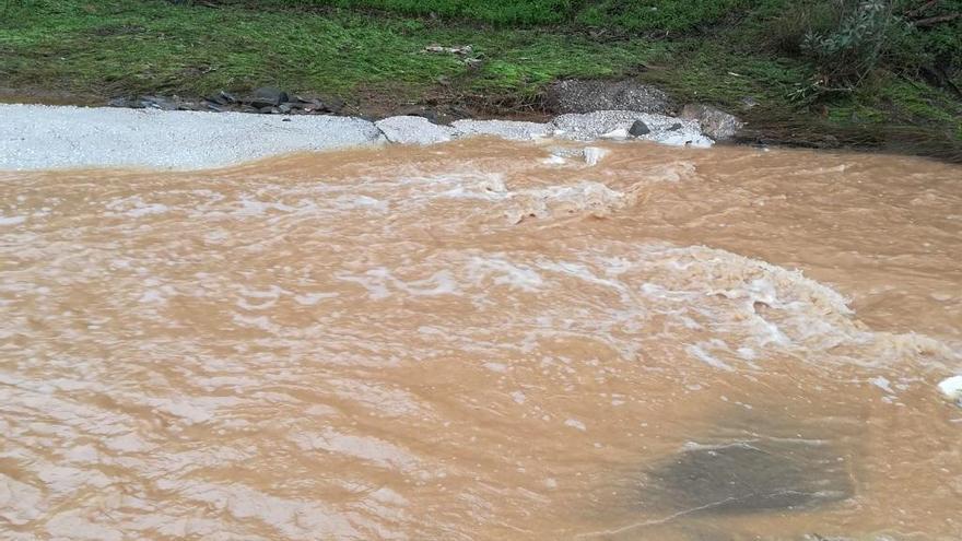 La subida del nivel del agua impide a los vecinos pasar por el arroyo.