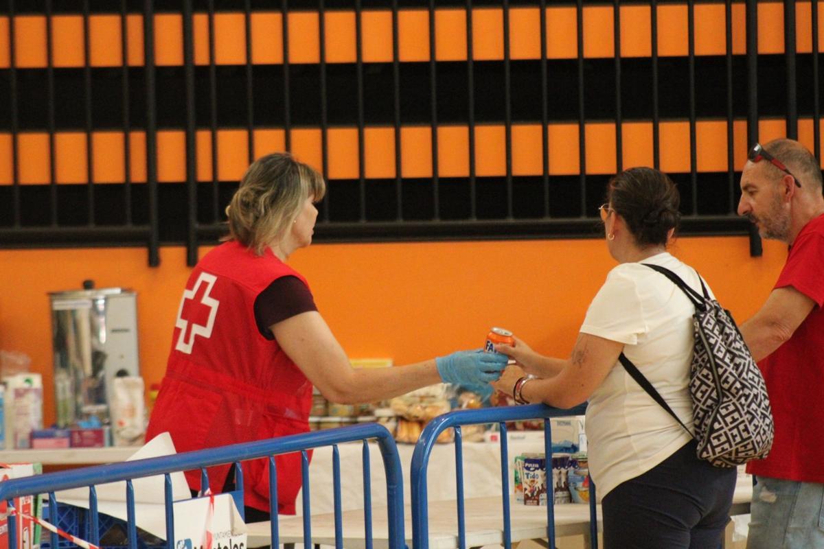 Miembros de Cruz Roja entregando bebida y almientos a las personas evacuadas