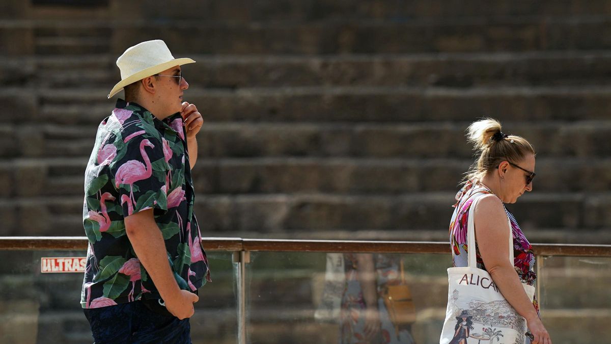 Personas con ropa veraniega y sombreros. A 18 de julio de 2025, en Málaga (Andalucía, España).