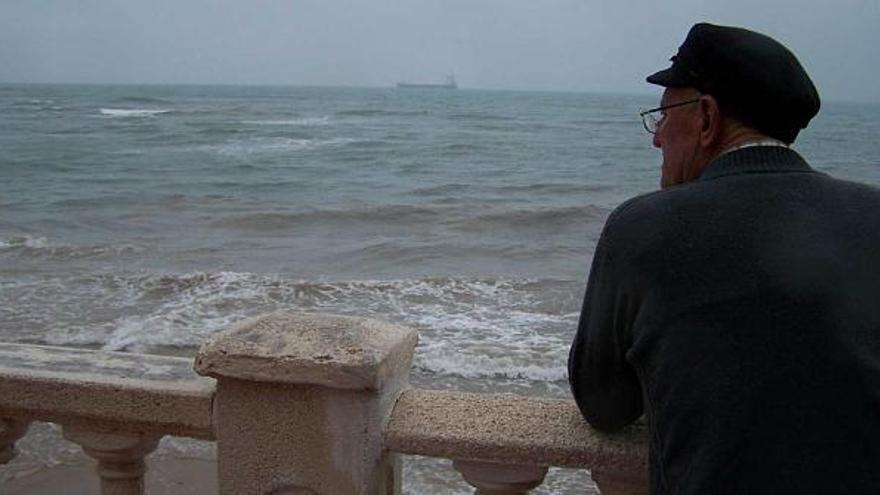 Una imagen ayer del temporal en Torrevieja y, al fondo, uno de los barcos que están esperando para cargar sal