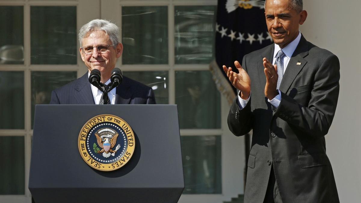 Judge Merrick Garland speaks at the podium in front of U.S. President Barack Obama in Washington