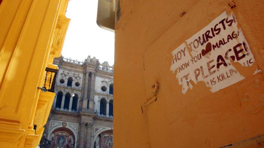 En algunas calles del Centro de Málaga han comenzado a aparecer carteles en contra de la masiva presencia de turistas.