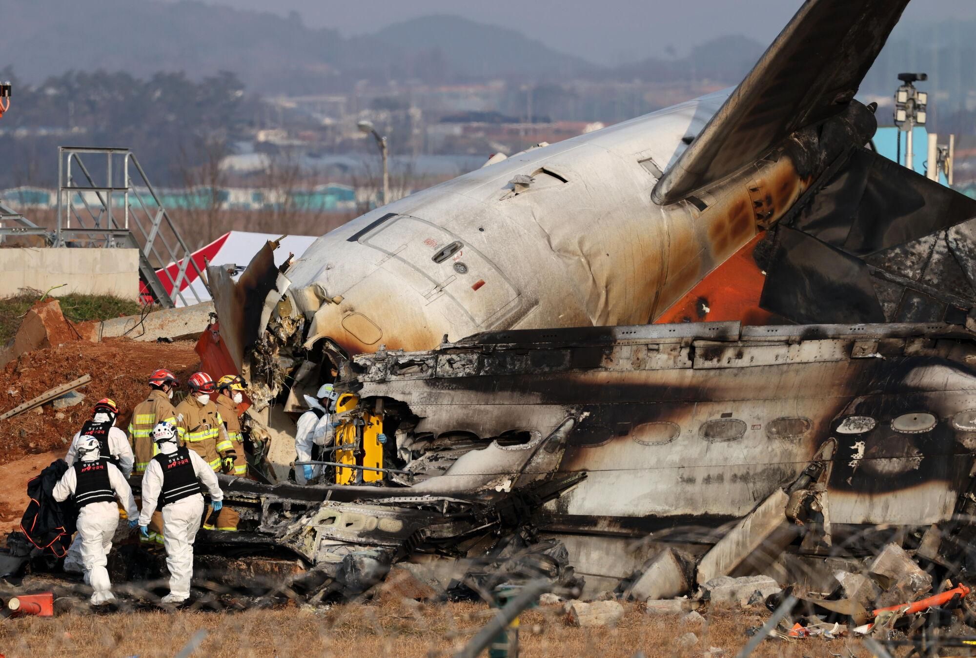 FOTODELDÍA  Muan (Corea del Sur), 29/12/2024.- Los bomberos trabajan en los restos del avión Jeju Air en el Aeropuerto Internacional de Muan, 29 de diciembre de 2024 . Las autoridades elevaron a 176 la cifra oficial de muertos en el accidente del avión comercial que se salió de la pista y chocó contra un vallado tras aterrizar. EFE/HAN MYUNG-GU