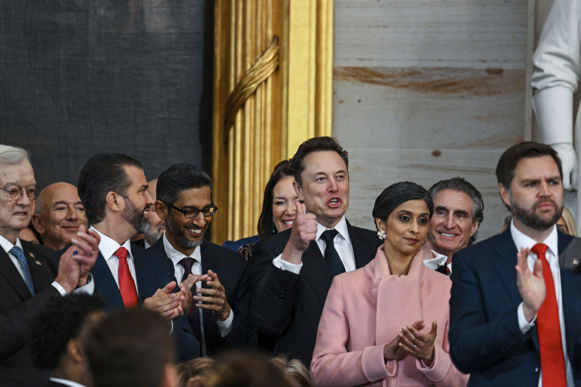 Jeff Bezos, from second left, Donald Trump Jr., Sundar Pichai, Elon Musk, Usha Vance, Doug Burgum and Vice President JD Vance applaud during the 60th Presidential Inauguration in the Rotunda of the U.S. Capitol in Washington, Monday, Jan. 20, 2025. (Kenny Holston/The New York Times via AP, Pool). POOL PHOTO; MANDATORY CREDIT