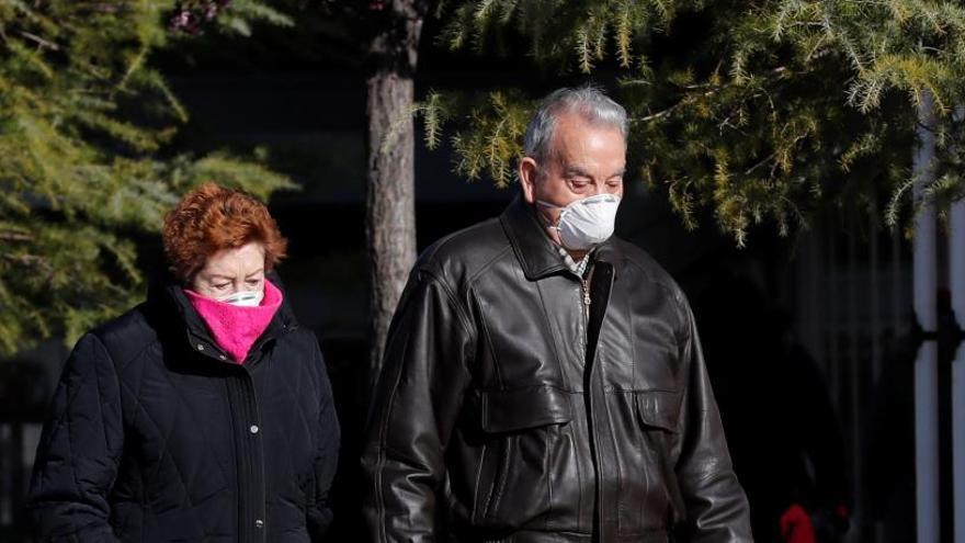 Una pareja con mascarillas en el exterior del Hospital Universitario de Torrejón de Ardoz.