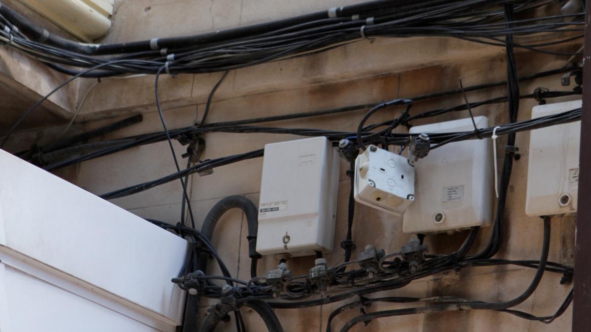 Unkontrolliertes Wirrwarr: Stromkabel an einer Häuserfassade im Zentrum von Palma de Mallorca.