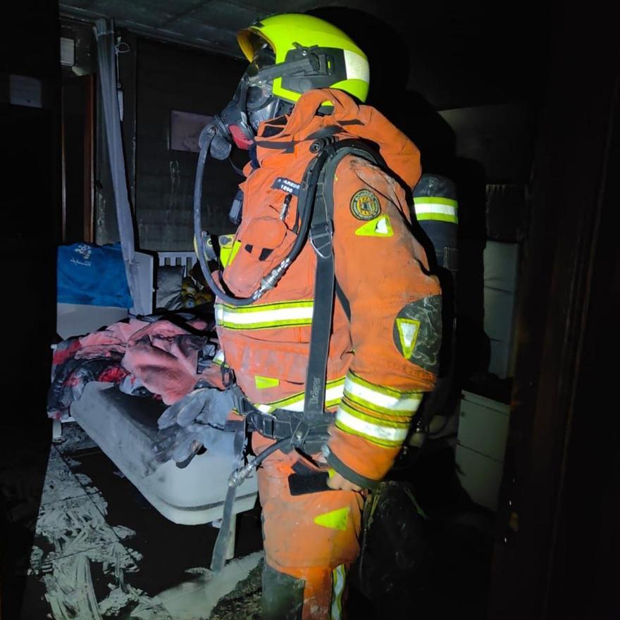 Un bombero en el interior de la vivienda afectada por el incendio en el que ha muerto un perro.