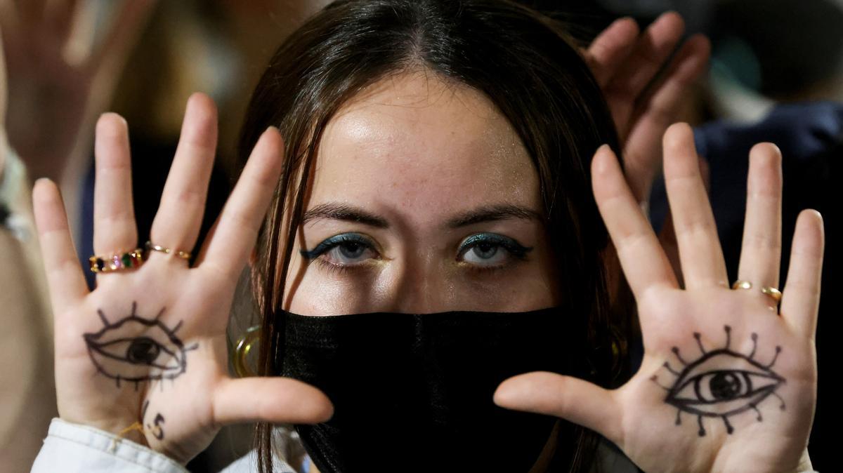 A person gestures as people protest during the UN Climate Change Conference (COP26), in Glasgow, Scotland, Britain, November 10, 2021. REUTERS/Yves Herman