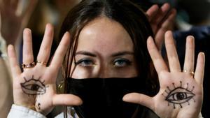 A person gestures as people protest during the UN Climate Change Conference (COP26), in Glasgow, Scotland, Britain, November 10, 2021. REUTERS/Yves Herman