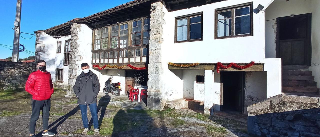 Marcos Rodríguez y Jesús García, delante de las edificaciones que hacen las veces de casa de acogida, situadas en Poo de Llanes. | Eva San Román