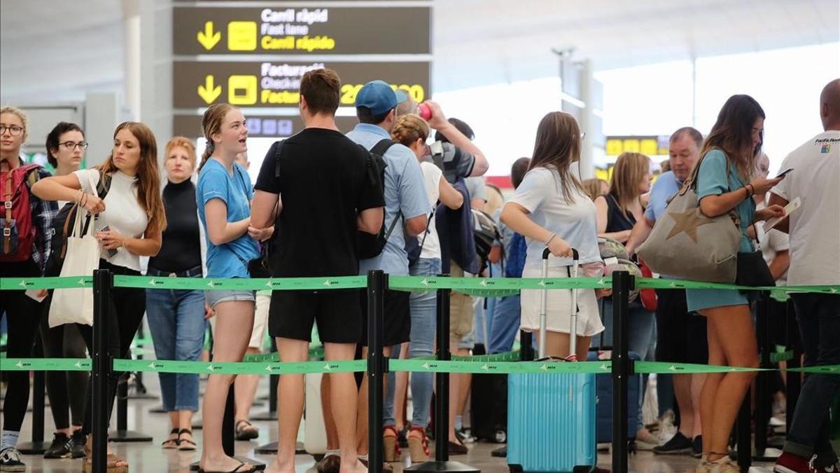 Pasajeros esperan para pasar los controles de seguridad en el aeropuerto de El Prat
