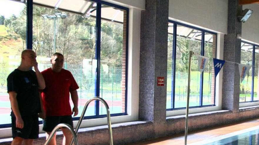 Dos trabajadores de la piscina climatizada de Pravia, en el interior de las instalaciones.