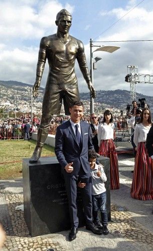 Portugal's Cristiano Ronaldo poses with his son during the unveiling of his statue at a tribute ceremony held in Funchal