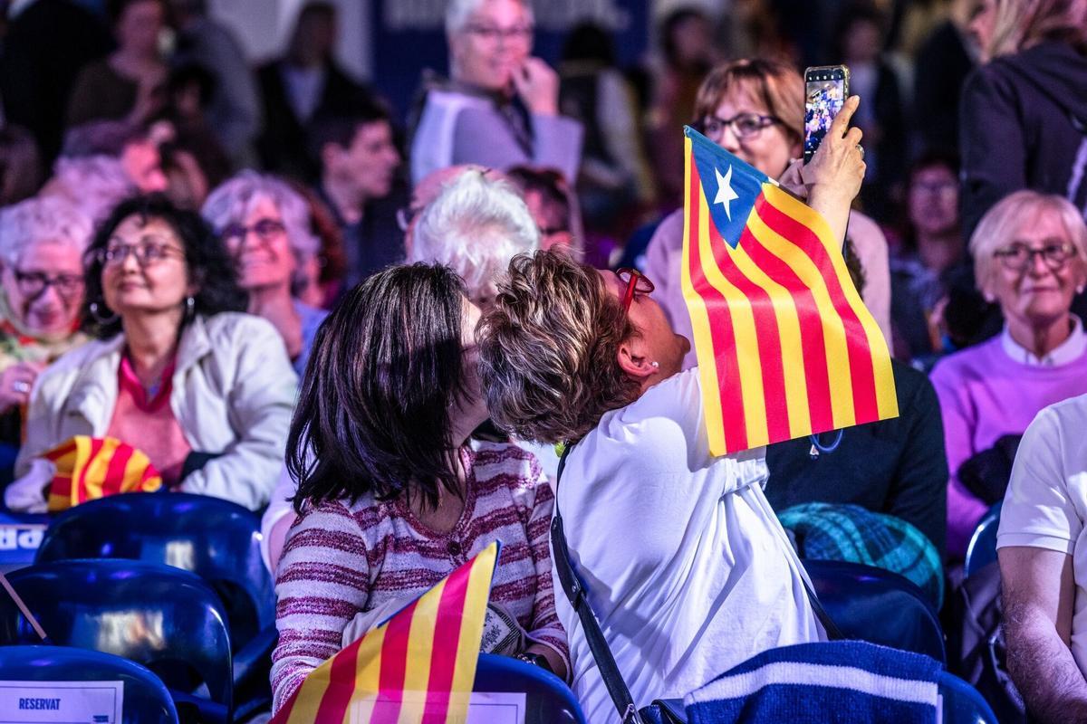 Dos señoras se hacen una 'selfie' mientras esperan que empiece el mitin de Puigdemont