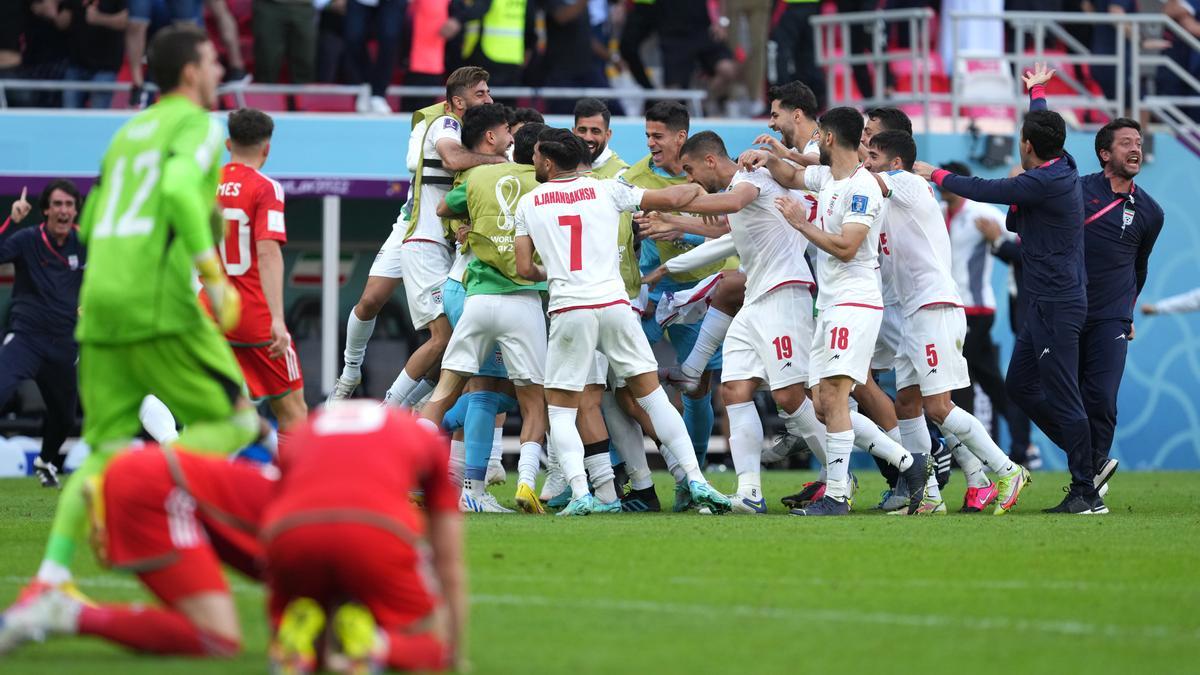 25 November 2022, Qatar, Ar-Rayyan: Iran's Roozbeh Cheshmi celebrates scoring their side's first goal of the game during the FIFA World Cup Qatar 2022 Group B soccer match between Wales and Iran at Ahmad bin Ali Stadium. Photo: Martin Rickett/PA Wire/dpa