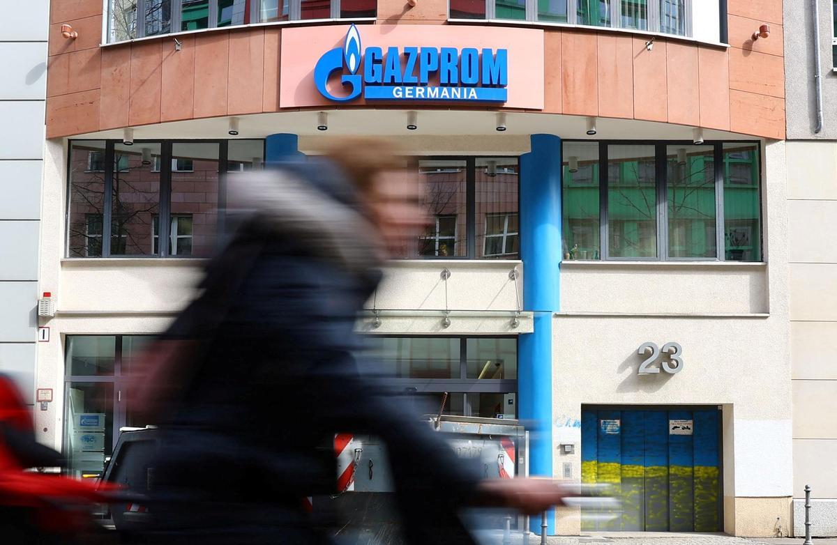 FILE PHOTO: A cyclist passes the headquarters of Gazprom Germania in Berlin