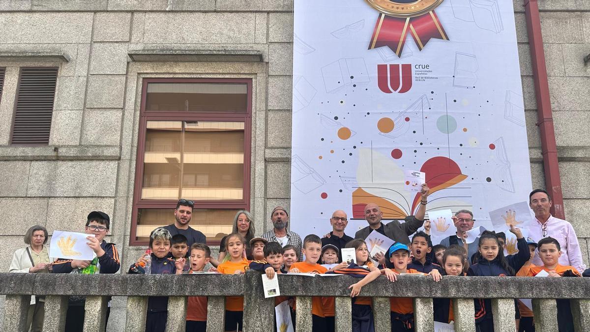 El alcalde de Porriño, Alejandro Lorenzo, con varios niños y niñas en la biblioteca municipal.