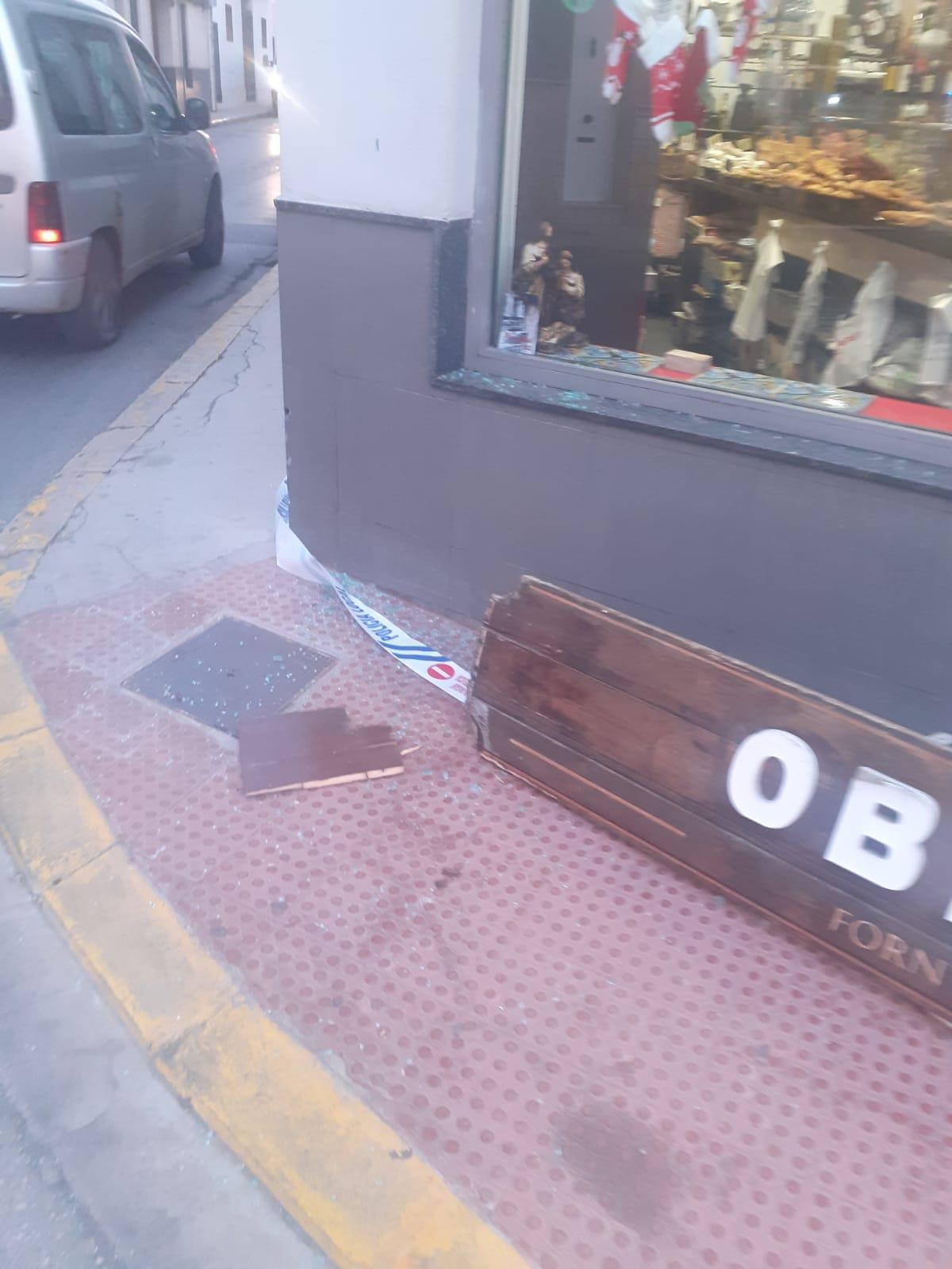 El impacto de un camión tira el cartel de uno de los comercios que están entre Rafael Valls y Valencia y rompe la cristalera.