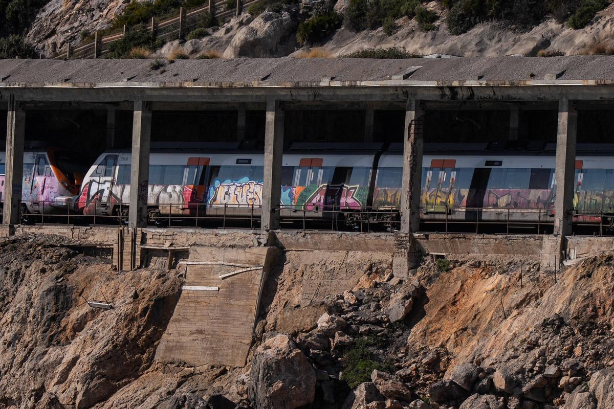Tunel con vías de tren afectadas y deterioradas donde pasan trenes de Rodalies.