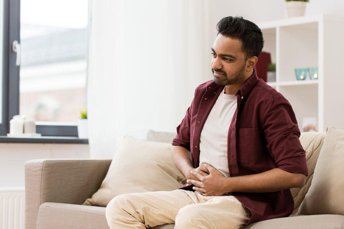 people, healthcare and problem concept - unhappy man suffering from stomach ache at home people, healthcare and problem concept - unhappy man suffering from stomach ache at home