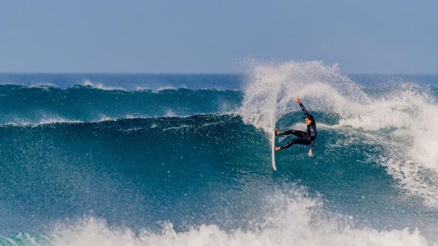 Keko Ferreiro cogiendo una ola sobre su tabla de surf.