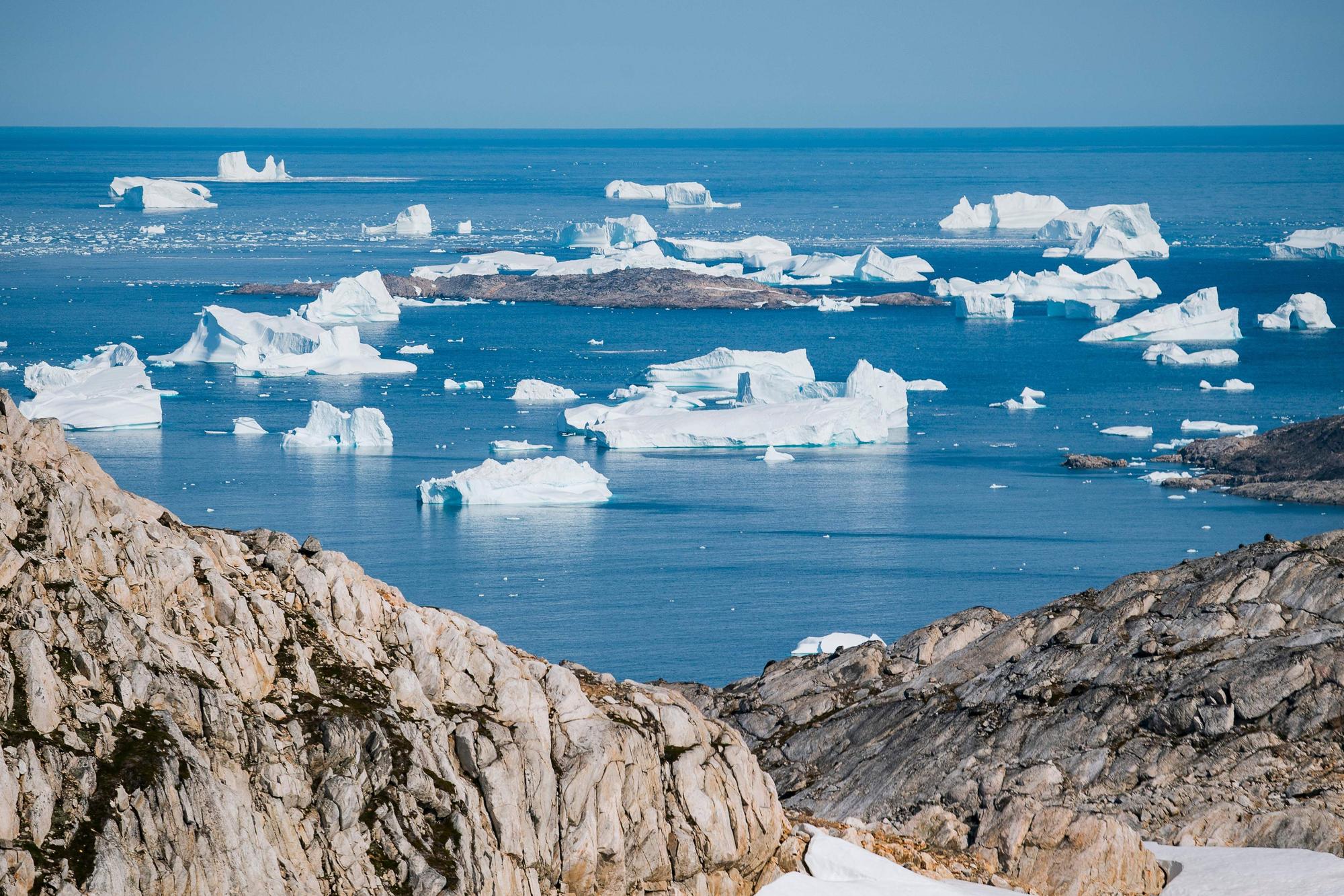 An aerial photo taken on August 15, 2019 shows icebergs as they float along the eastern cost of Greenland.