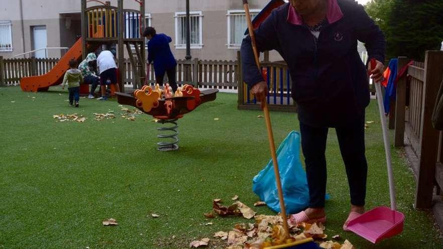 Abuelas usuarias del parque infantil se encargan de la limpieza y el mantenimiento. // Rafa Vázquez