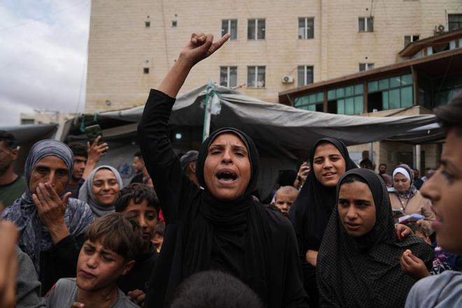 Palestinians celebrate following the announcement that Israel and Hamas have agreed to the first phase of a peace plan to pause the fighting, outside Al-Aqsa Hospital in Deir al-Balah, central Gaza Strip, Thursday, Oct. 9, 2025. (AP Photo/Abdel Kareem Hana)