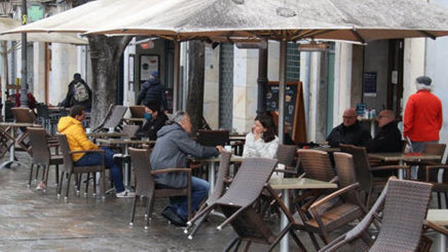 Algunes terrasses de la Rambla de Girona a mig matí amb gent esmorzant i fent el cafè el 8 de març de 2021