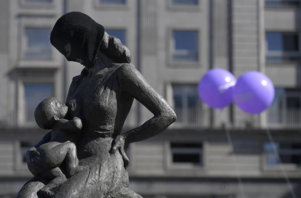 Sculpture is covered with black mask during a ...