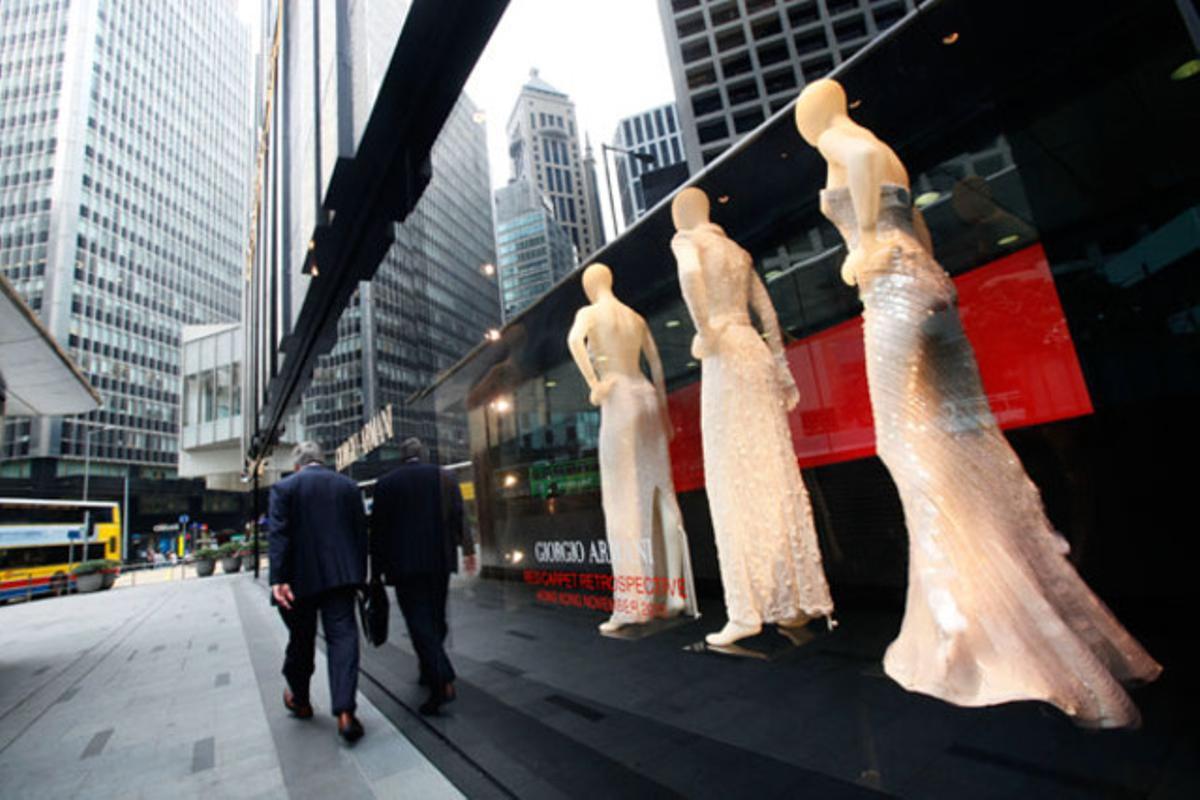 Un home passa per davant d’una botiga de roba de luxe a la zona de negocis de Hong Kong (Xina).