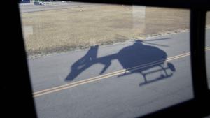 Archivo - Sombra de uno de los helicópteros Pegasus de la DGT.