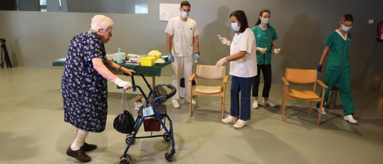 Una usuaria de la residencia Elias Martínez, en Zaragoza, acude a vacunarse contra la gripe y el covid, este mes.